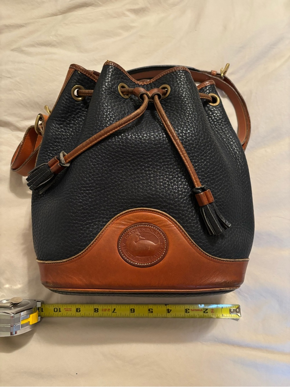 Dooney & Bourke Black Pebbled Leather and Brown Trim Drawstring Bucket Bag